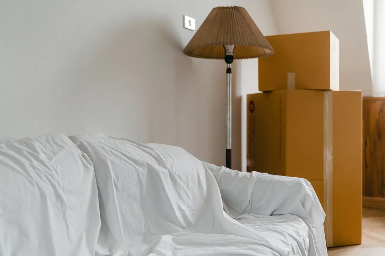 Furniture covered and boxes packed in a Seattle, WA apartment at the end of a tenancy